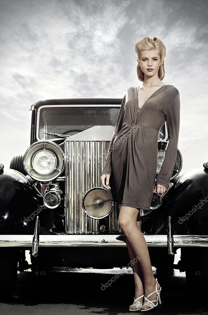 Elegant girl poses near retro car