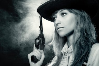 Beautiful girl in hat, with a revolver clipart