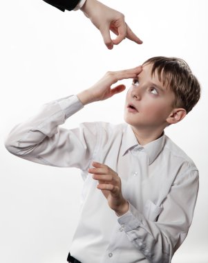Boy rubs a forehead after blow clipart