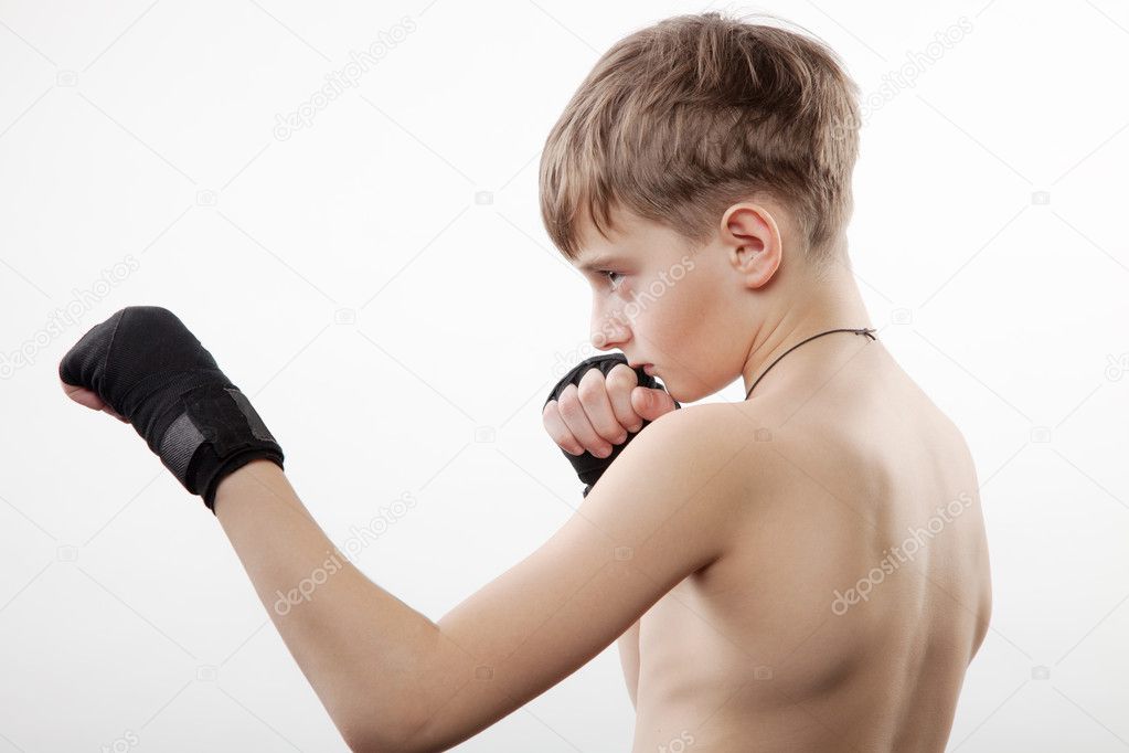 Young boy the boxer trains blow in strap