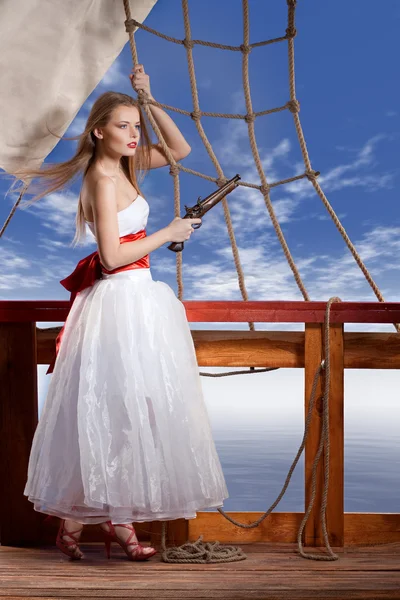 Beautiful girl in white dress on deck of the sailing ship — Stock Photo, Image