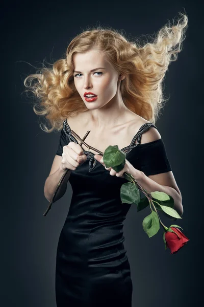 Beautiful girl in black dress with broken rose — Stock Photo, Image