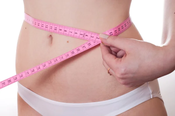 The girl measures waist volume — Stock Photo, Image