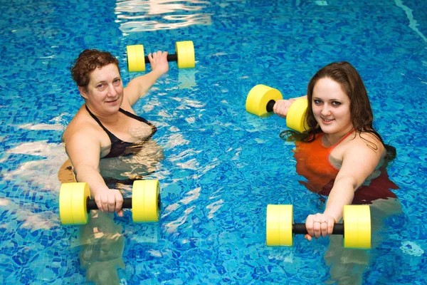 Two womam in water with dumbbells — Stock Photo, Image