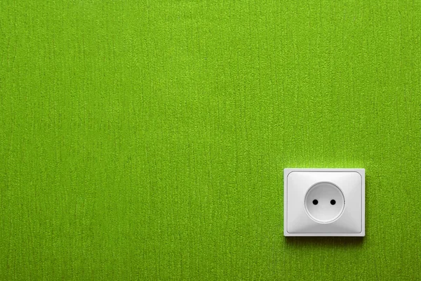 The electric socket in a green wall — Stock Photo, Image