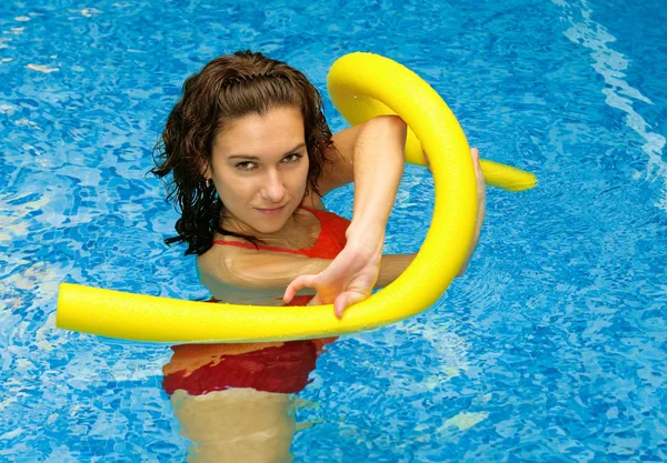 Woman is water with aqua noodles — Stock Photo, Image