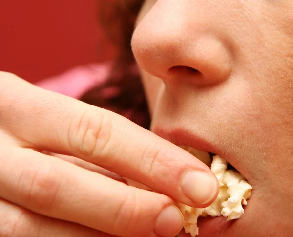 stock image The girl eats popcorn