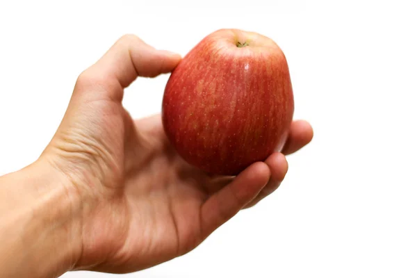 Apple in a hand on a white background — Stock Photo, Image