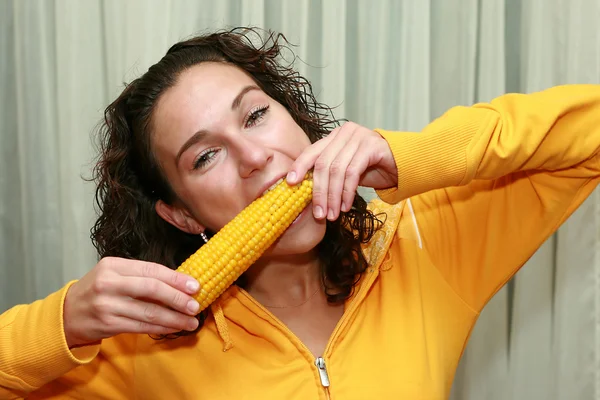 Stock image Young funny girl eating corn