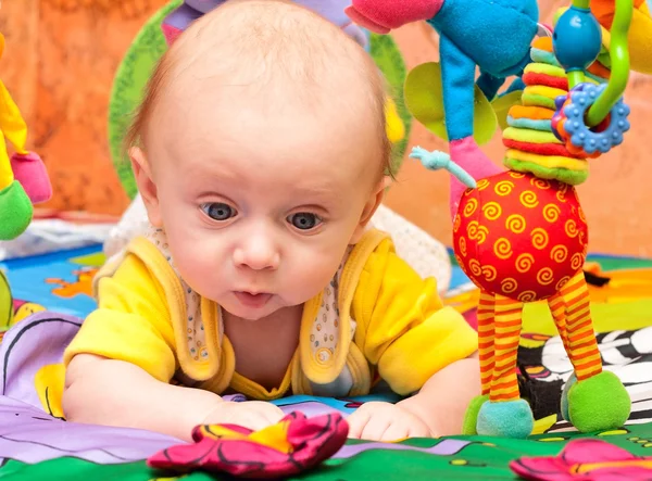 Baby plays in baby gym — Stock Photo, Image