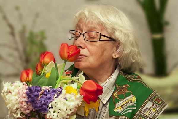 Stock image Grandmother with flowers