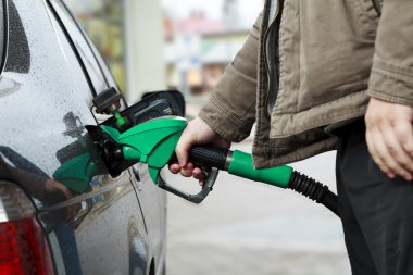 Refilling Car at Gas Station clipart