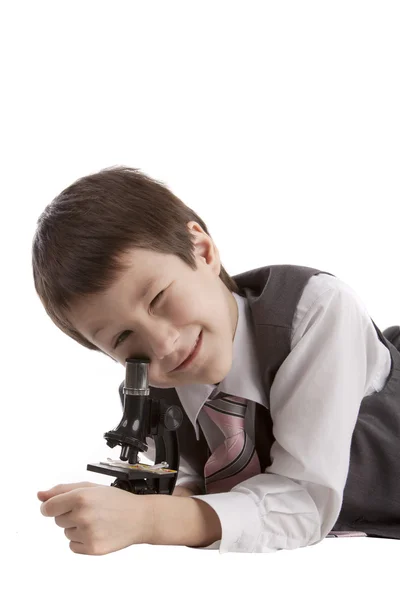 男孩用显微镜 图库图片