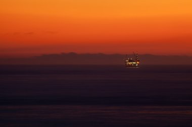 Offshore Oil Rig Drilling Platform at Sunset clipart