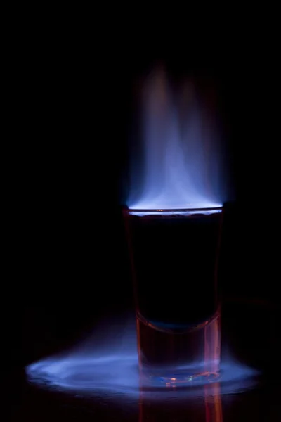 Brandende drankje in shot glas op een tafel — Stockfoto