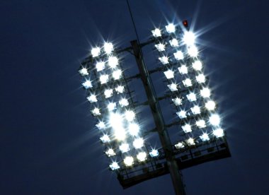 Stadium lights and dark blue sky clipart