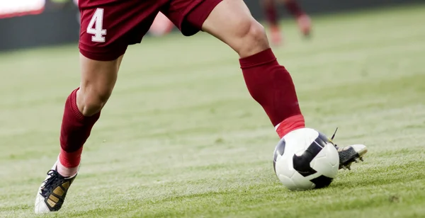 Fußballer läuft dem Ball hinterher — Stockfoto