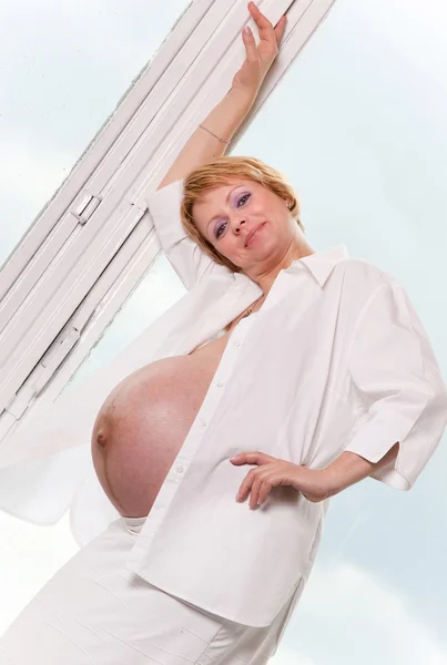 Mulher grávida bonita na frente de um espelho — Fotografia de Stock