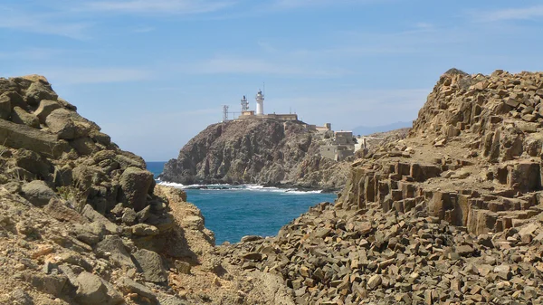 Basalt tiles quarry and lighthouse at the bottom. — Stock Photo, Image