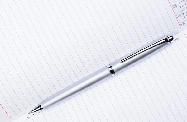 Silver pen on notebook — Stock Photo, Image