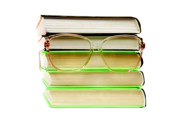 Stack of books with glasses isolated — Stock Photo, Image