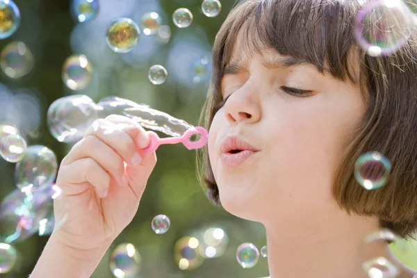 Child blowing bubbles — Stock Photo, Image