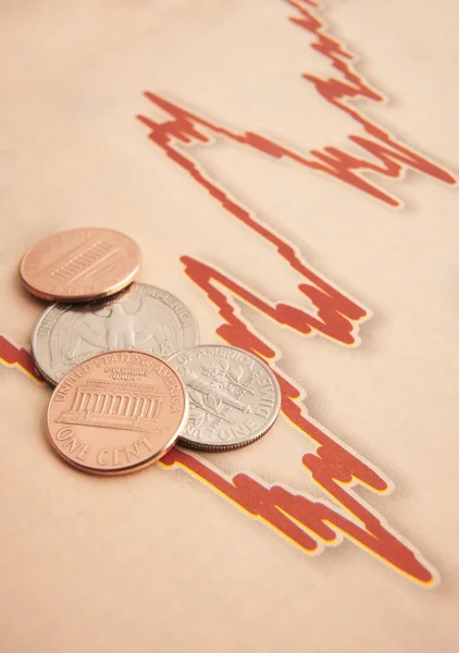 Monedas en papel gráfico — Foto de Stock