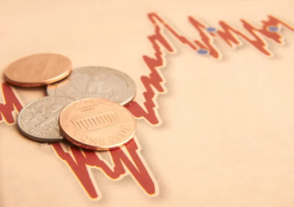 Monedas en papel gráfico —  Fotos de Stock