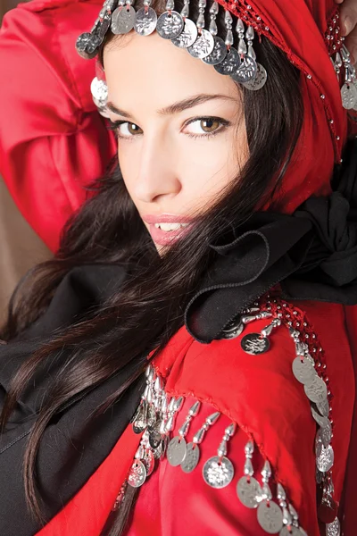 Beautiful young girl cover with red scarf — Stock Photo, Image