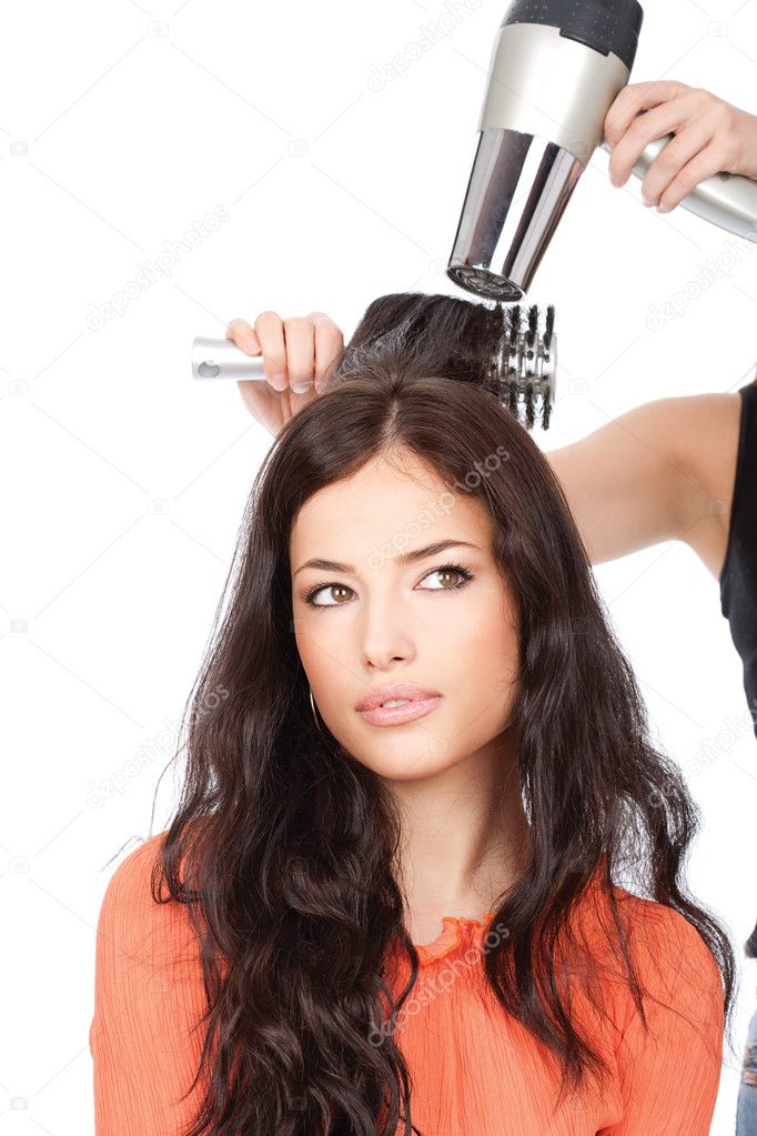 Hairdresser is drain a long black hair