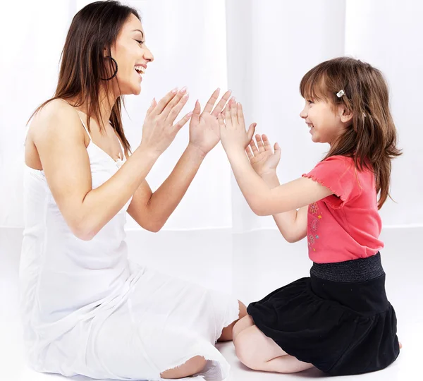 Woman and child laughing and playing — Stock Photo, Image