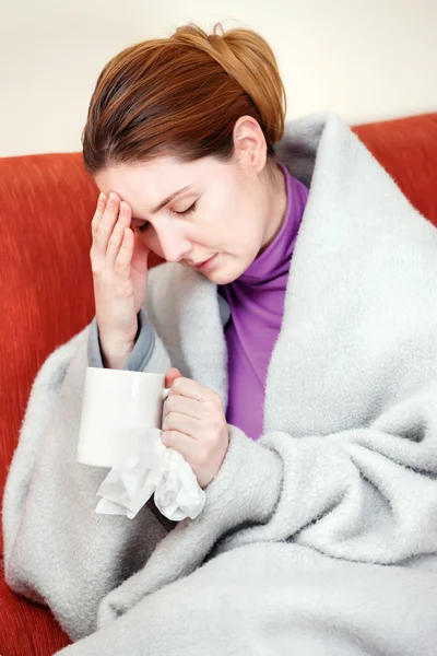 Sick woman with a cup of tea in her hand — Stock Photo, Image