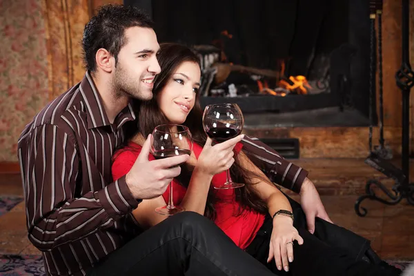 Happy couple near fireplace — Stock Photo, Image