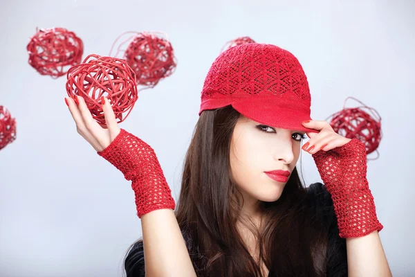 Vrouw met rode hoed, bedrijf rode bal — Stockfoto