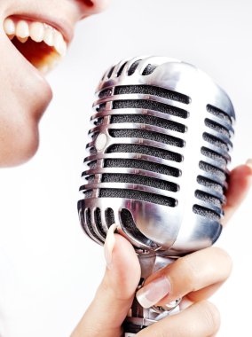 Woman singing on retro microphone