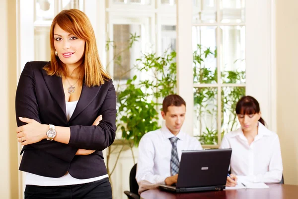 Knappe vrouwelijke manager met werkgevers in office — Stockfoto