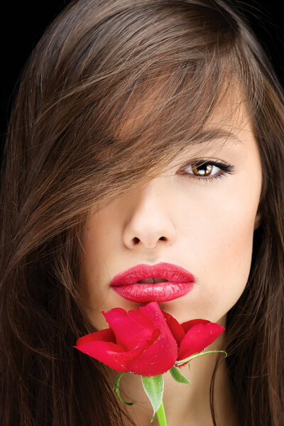Pretty young brunette woman and red rose