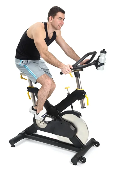 Un hombre haciendo ejercicio de ciclismo indoor — Foto de Stock