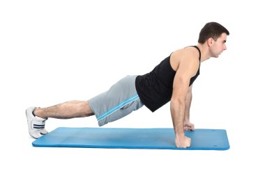 Young man performing push-ups exercise on fists clipart