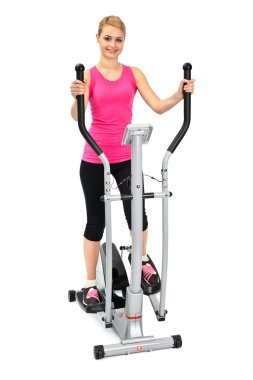 Young woman doing exercises on elliptical trainer clipart