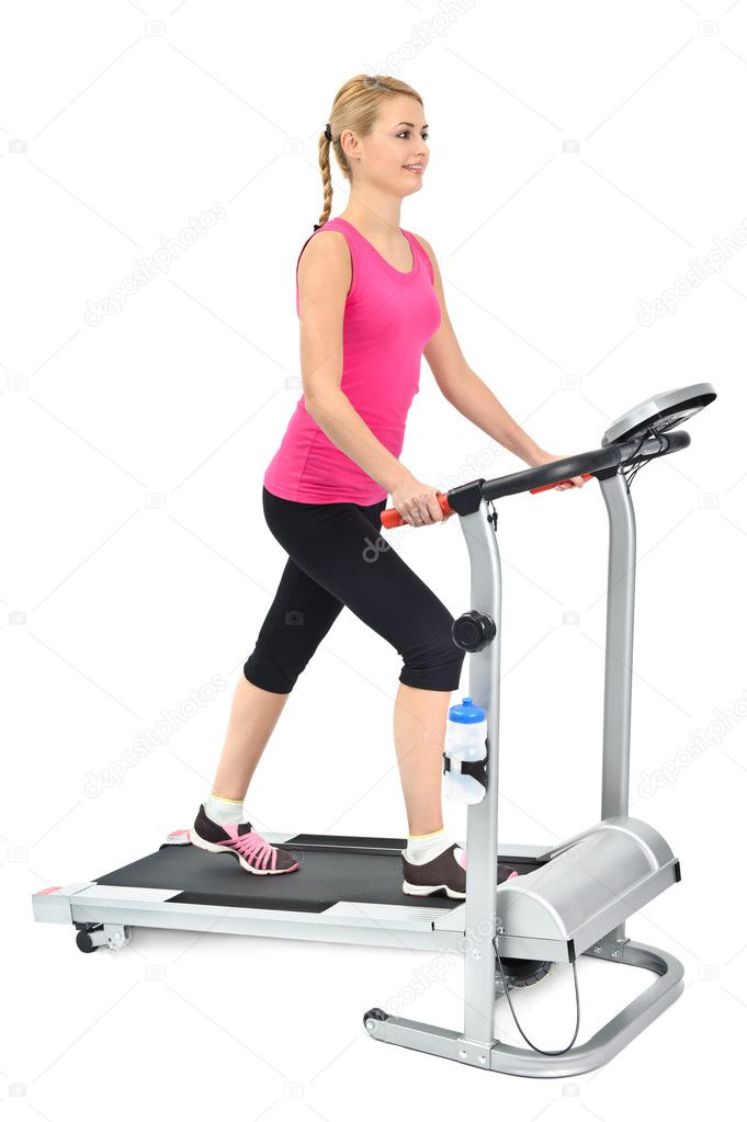 Young woman doing exercises on treadmill