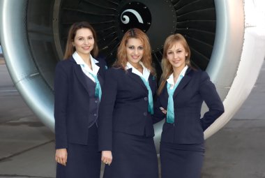 Air hostesses in front of engine clipart