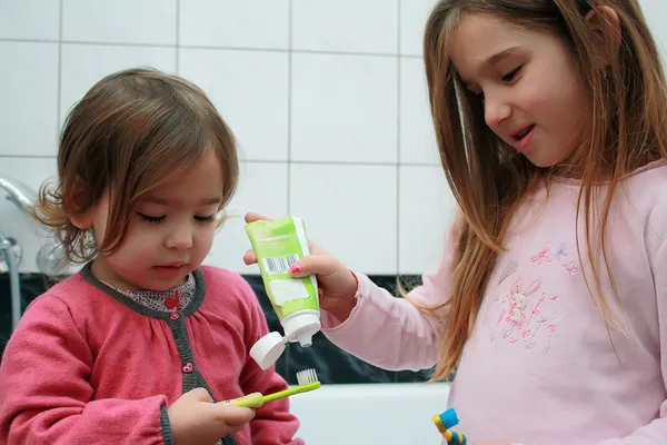 Duas meninas no banheiro escovando os dentes — Fotografia de Stock