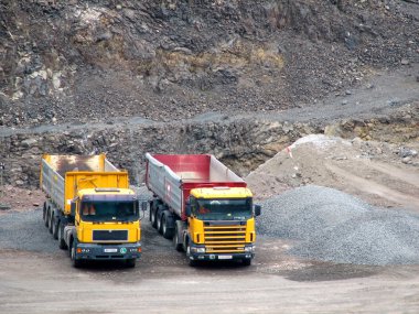 Trucks in the open pit clipart