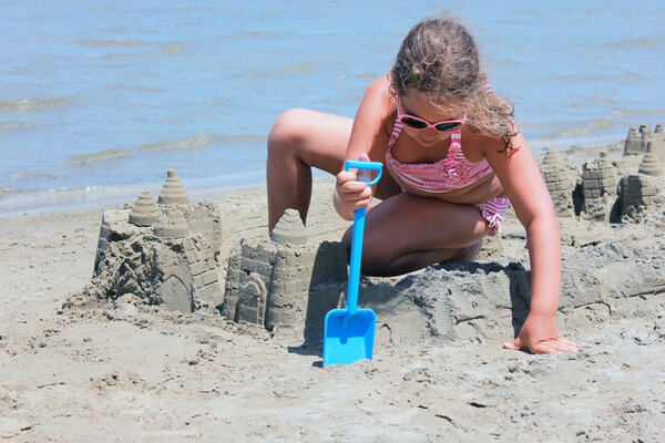 Girl playing in the sandy beach