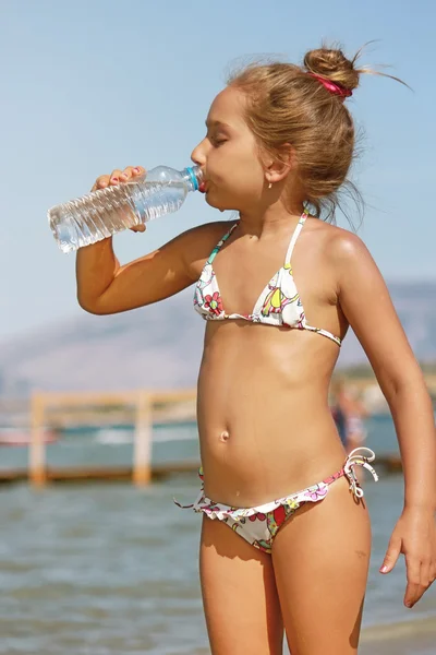 Girl drinking water from the bottle — Stock Photo, Image