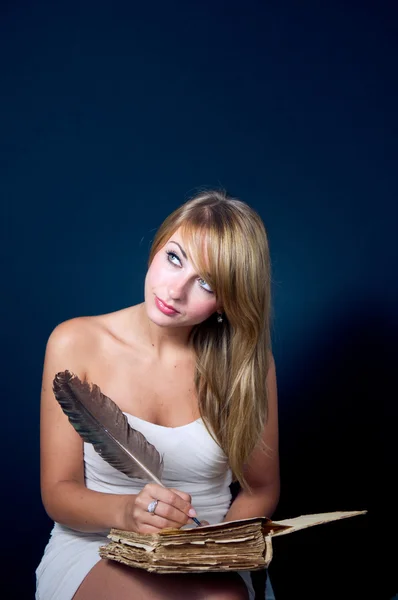 Girl writing with quill pen — Stock Photo, Image