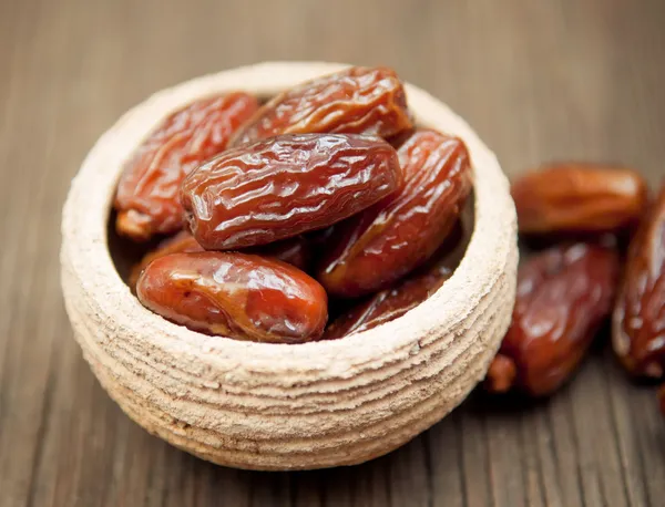 Delicious dates in small bowl — Stock Photo, Image