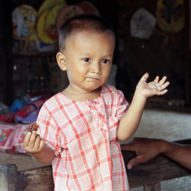 Young child with funny face in Bagan, Myanmar clipart