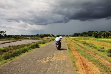 Myanmar landscape with a small road before the storm clipart